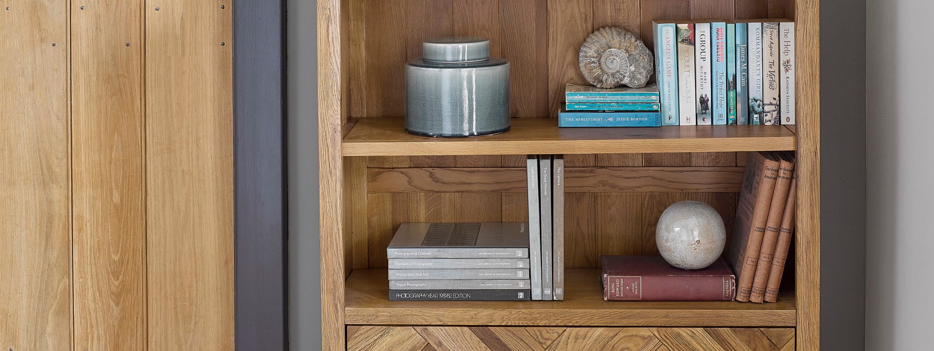 Small parquet sideboard on a landing styled with plants and books